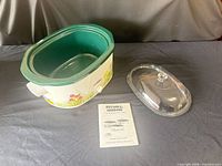 Slow cooker with lid and manual displayed