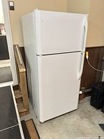 Full exterior view of white top-freezer refrigerator
