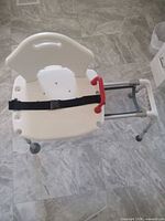 Top view showing seat, backrest, red handle and safety belt