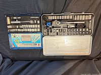 Both storage cases open showing full assortment of sockets and tools