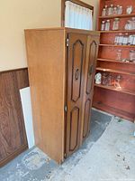 front and side view of walnut veneer cabinet showing two raised-panel doors and overall height