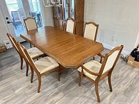 table with six side chairs and two armchairs around it