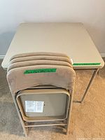 Table folded with four stacked chairs