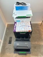 Full stack view showing boxed toner, printer, filing cabinet, shredder