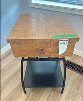 Full view of side table showing veneer top, drawer, metal base and shelf