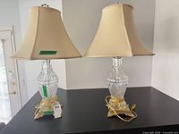 Front view of both crystal table lamps showing shades, bodies, bases, and cords