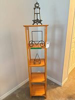 Full view of wood etagere with three metal easels displayed