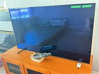 Front view of 65-inch Sony TV on cabinet