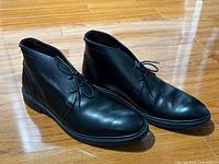 Oblique view of both boots showing leather condition and sole edge