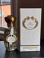 Front view of bottle and box showing design and labeling