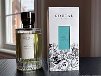 Front view of perfume bottle beside original box