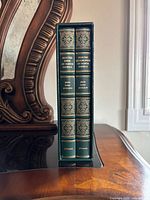 Spine view of both volumes inside slipcase showing titles and gilt decoration
