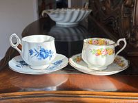Front view of both tea cup and saucer sets