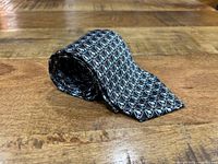 Rolled Faberge silk tie showing overall print pattern