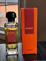 Bottle positioned beside original box