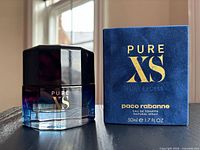 Bottle and box front view displaying branding and size