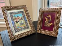 Both framed artworks standing side by side