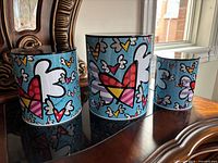 Front view of all three canisters showing artwork and size graduation