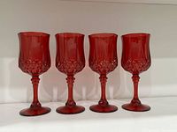 Front view of four ruby red goblets aligned