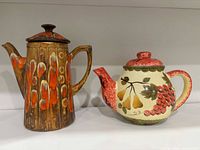 Both teapots side by side on shelf