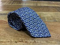 Rolled tie showing knit pattern and colors