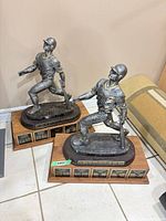 Both trophies showing figures and bases