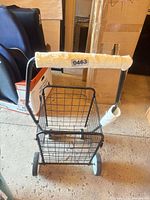 Overall view of black wire cart showing basket and wheels