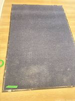 Full view of blue area rug on wood floor