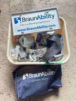 Overall kit in tub showing sign plate, hardware, straps and storage bag