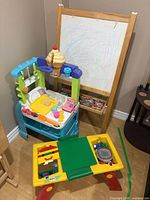Overview showing easel, play stand, activity table, bricks and play food