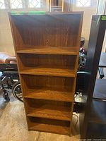 Front view of medium oak veneer five-shelf bookcase