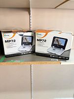 Two Mustek MP72 retail boxes on shelf