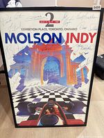 Front view of framed Molson Indy 1987 poster with signatures visible