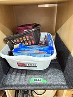 White tub holding black and burgundy baskets and Paper Mate pen boxes