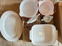 All pieces laid out: platter, two mixing bowls, spoon, gravy boat, casserole dish