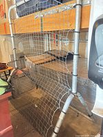 full view of rebounder showing frame, net, and base supports