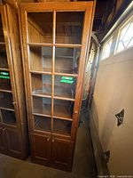 Full front view of china cabinet showing glass door, lower storage, finish