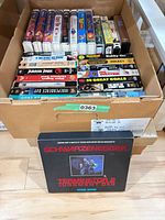 Box containing Disney titles, sports compilations and Terminator 2 set