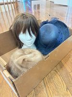 Mink fur hat, navy veiled straw hat, brown wig on foam head inside box