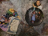 Both Wizard of Oz plates and certificate visible in bubble wrap