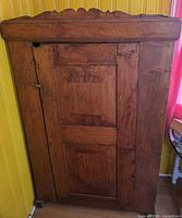 Front view of solid wood cupboard with single door