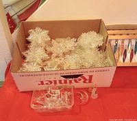 Box of snowflake ornaments and clear glass pieces