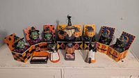 Group shot of all jack-in-boxes, witch figures and candle set