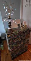 Full view of dresser top with lamp, mirror, candlesticks, poem frame