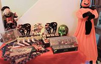 Overall lot on table with witch doll, plates, skull, ornaments