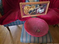 Striped ottoman with red light shade and Elvis wall art