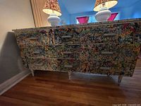 Front view of painted nine-drawer dresser with lamps on top