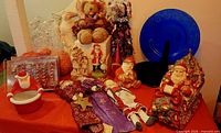 Full lot view with charger, dolls, bears, ornaments and ceramics