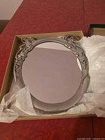 Pewter oval vanity mirror in box with tissue