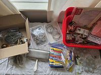 Overview of mixed hardware, rings, novelty items in trays and boxes